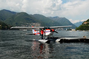 cot standing on float..seaplane in distance